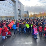 Einige hundert Menschen stehen vor dem Bremer Airbus-Werk während einer Kundgebung der Gewerkschaft IG Metall.