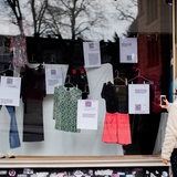Eine Person fotografiert die Ausstellung "Was ich anhatte" mit Kleidungsstücken von Opfern sexualisierter Gewalt. 