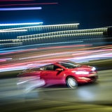 Ein Auto fährt schnell in der Nacht 