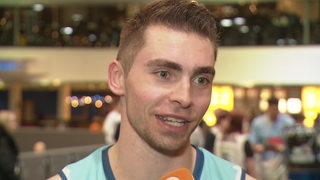 Basketball Adrian Breitlauch von den Eisbären Bremerhaven lächelt bei einem Interview nach dem Spiel.