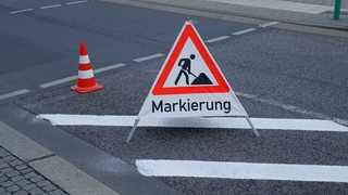Auf einer Straße steht das Schild "Markierung".