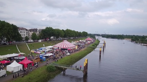 Eine Luftaufnahme von dem Breminale Festival mit Zelten und vielen Menschen am Osterdeich in Bremen.