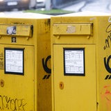 Zwei gelbe Briefkästen nebeneinander-