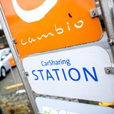 Ein Schild mit der Aufschrift "CarSharing Station" steht an einem Parkplatz.