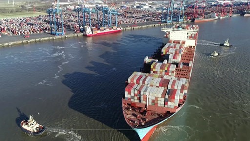 Ein großes Containerschiff im Hafen. 