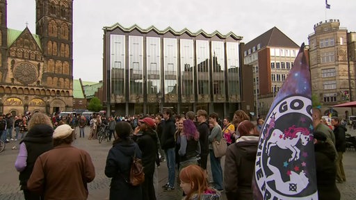 Vor der Bremer Bürgerschaft nehmen zahlreiche Menschen an einem Protest teil.