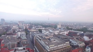 Eine Luftbildaufnahme der Bremer Innenstadt bei Nebel. Die Gebäude liegen in blaugrauen Dunst.