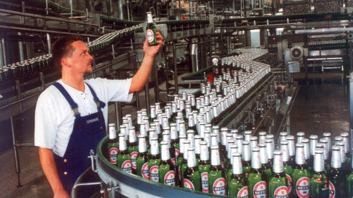 Ein Mitarbeiter der Brauerei Beck & Co. in Bremen bei der Kontrolle an der Flaschenabfüllanlage.