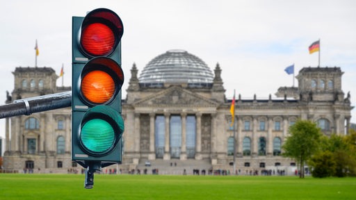 Ein Ampel vor dem Reichstagsgebäude in Herbststimmung als Symbol