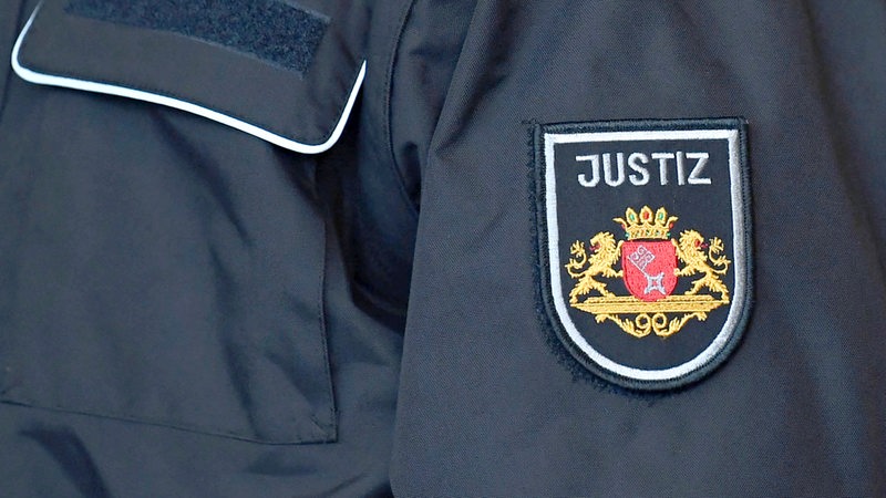 Auf dem Ärmel einer Jacke steht "Justiz".