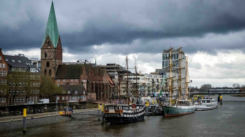 Dunkle Wolken ziehen über die Innenstadt und die Weser.