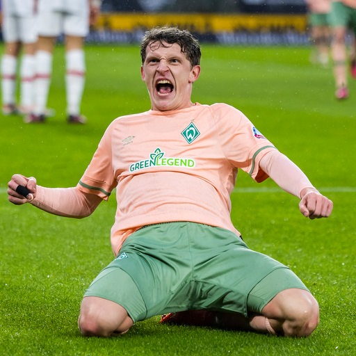 Werder-Profi Jens Stage rutscht jubelnd auf den Knien und schreit seine Freude über sein Tor gegen Stuttgart hinaus.