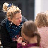 Eine Erzieherin spricht in einer Kita mit Kindern