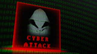 Auf einem Computerbildschirm steht "Cyber Attack"