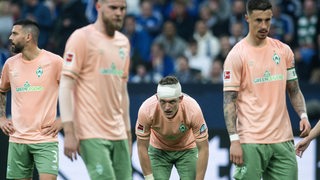 Enttäuschte Werder-Spieler nach der Niederlage gegen Schalke, Jens Stage trägt einen Kopfverband.
