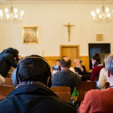 Ein Flüchtling hört sich am 21.03.2016 die Übersetzung eines Pressegespräches zu christlichen Flüchtlingen und ihrer Unterbringung in der katholischen Kirche St. Elisabeth in Berlin, in Arabisch über Kopfhörer an.