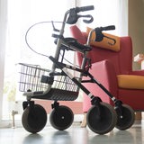 Ein Rollator steht vor einem leeren Sessel.