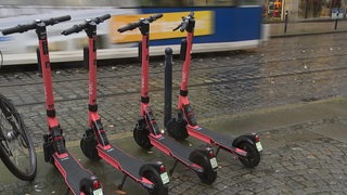 Zu sehen sind E-Scooter am Straßenrand in Bremen. 