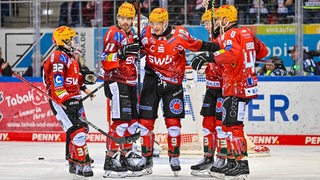 Eishockey-Spieler der Fischtown Pinguins bejubeln gemeinsam einen Treffer gegen Schwenningen.