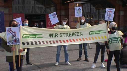 Eine Gruppe aus sechs Leuten halten ein Wir Streicken Banner der GDL in den Händen.