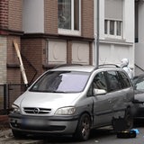 Zwei Spurensucher der Polizei stehen vor einem Hauseingang.