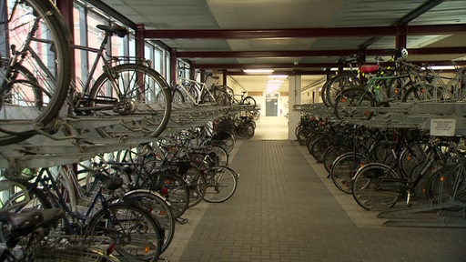 Das Fahrradparkhaus am Bremer Hauptbahnhof von innen. In zwei Reihen stehen Fahrräder nebeneinander an Ständern.