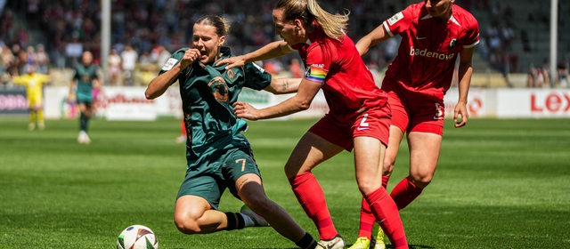 Werder-Stürmerin Larissa Mühlhaus stürzt im Zweikampf mit einer Freiburger Spielerin.