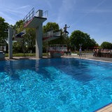 Ein Junge springt im Freibad in Weyhe ins Wasser.