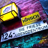 An einer Wand ist ein Schild mit der Aufschrift "Die Friese Jugendzentrum" zu sehen.