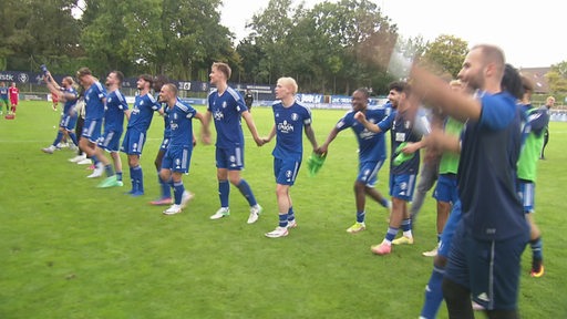 Es sind die Spieler des Bremer SV´s nach ihrem Sieg auf dem Spielfeld zu sehen.