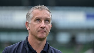 Werder-Geschäftsführer Frank Baumann schaut vor dem Anpfiff nachdenklich nach oben.