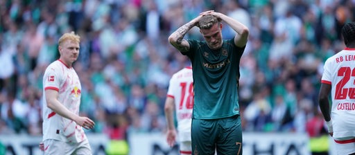 Werder-Stürmer Marvin Ducksch hält frustriert die Hände über den Kopf nach einer verpassten Torchance gegen Leipzig.
