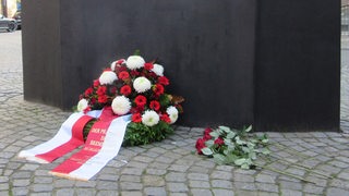 Kranz und Blumen vor dem Mahnmal zum Gedenken an die Opfer der Reichspogromnacht in Bremen.