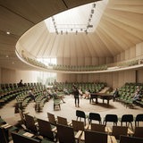 Mehrere Menschen sitzen in einem runden Saal.