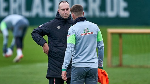 Werder-Coach Ole Werner während des Trainings im Gespräch mit Stürmer Niclas Füllkrug.