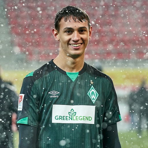 Werder-Talent Fabio Chiarodia lächelt im Schneeregen nach einem ersten Einsatz für Werder.