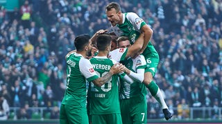 Die Werder-Spieler feiern einen Treffer.