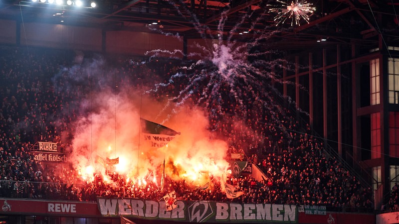 Werder-Fans zünden im Kölner Stadion Pyrotechnik und Feuerwerkskörper.