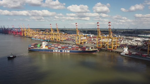 Ein Container-Schiff am Hamburger Hafen aus der Vogelperspektive zu sehen.