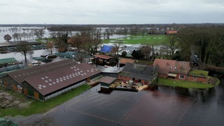 Ein überfluteter Bauernhof von oben.
