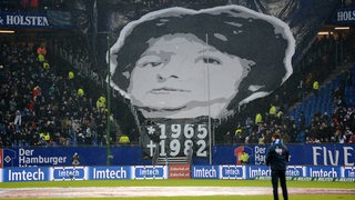 Werder-Fans rollen im Hamburger Stadion ein Transparent mit dem Bild des getöteten Fans Adrian Maleika über dem Gästeblock aus.