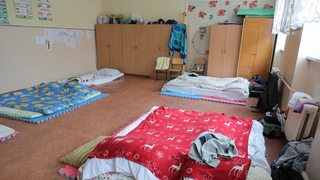 Eine Raum mit mehreren Bettenlagern aus Matratzen.