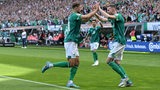 Die Werder-Stürmer Marvin Ducksch und Niclas Füllkrug klatschen sich jubelnd nach Füllkrugs Treffer gegen Regensburg ab.