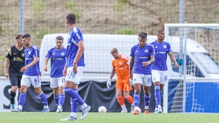 Schalker Spieler schauen nach einem Gegentreffer frustriert.