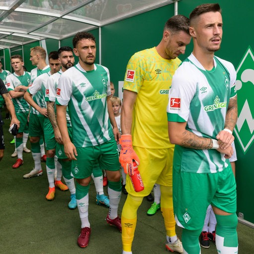 Werder-Kapitän Marco Friedl wartet mit seinen Teamkollegen im Spielertunnel.