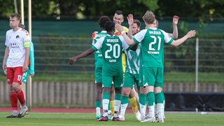 Fußball-Spieler von Werders U23 Mannschaft bejubeln gemeinsam einen Treffer gegen Lübeck.