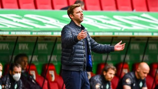 Werder-Trainer Florian Kohfeldt breitet an der Seitenlinie frustriert die Arme aus.