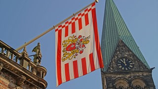 Bremer Flagge am Rathaus und Blick auf die Uhr am Dom. (Archivbild)