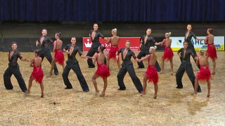 Die Lateinformation der TSG Bremerhaven in roten und schwarzen Kostümen bei der Generalprobe der Choreo "Time Machine".