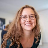 Eine junge Frau mit Brille, Josephine Assmus, lächelt in die Kamera 